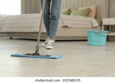 Woman Cleaning Floor With Mop At Home, Closeup