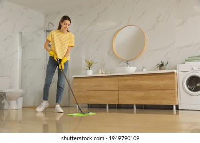 Woman Cleaning Floor With Mop At Home