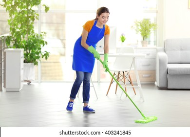 Woman Cleaning Floor With Mop Indoors