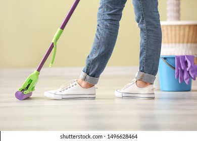 Woman Cleaning Floor In Room