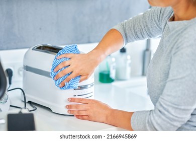 Woman Cleaning Grill Or Toaster Machine In The Kitchen