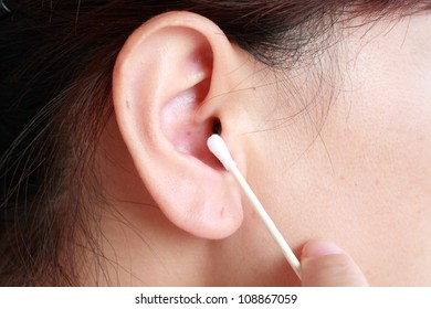  Woman Cleaning Her Ear With Cotton Swab