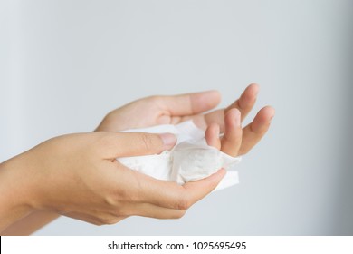 Woman cleaning her hands by using white tissue paper.  isolated on a white background.