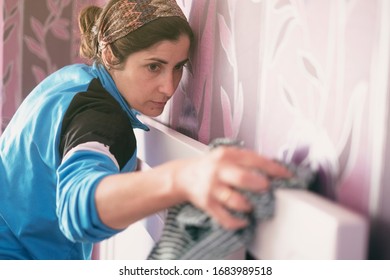 Woman Cleaning At Home. Headboard Of A Bed