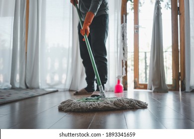 Woman Cleaning House In The Living Room With Mop.