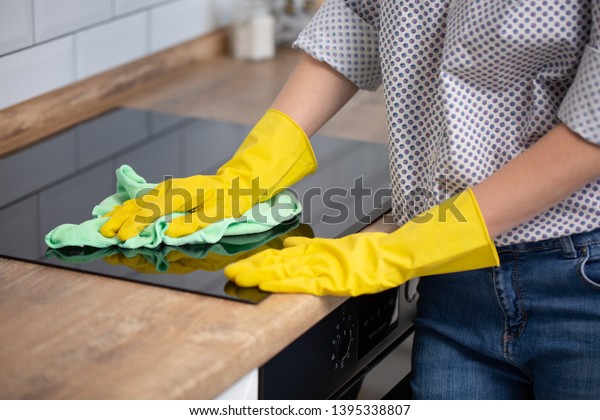 Woman Cleaning Induction Top Hand Yellow Royalty Free Stock Image