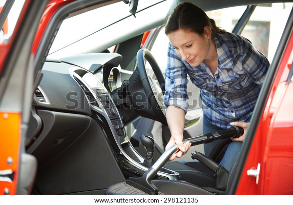Woman\
Cleaning Interior Of Car Using Vacuum\
Cleaner