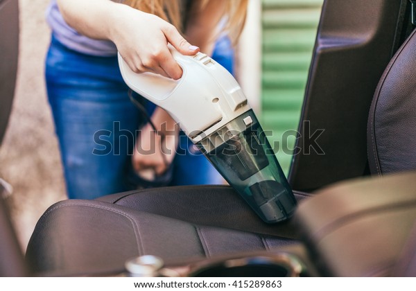 Woman\
Cleaning Interior Of Car Using Vacuum\
Cleaner