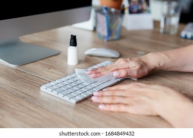 Woman Cleaning Keyboard In The Office