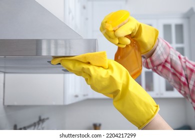 Woman cleaning kitchen hood with rag and detergent indoors, closeup - Shutterstock ID 2204217299