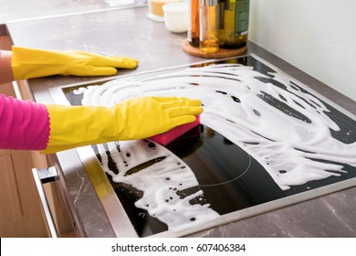 Woman Cleaning Kitchen Stove