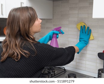 Woman Cleaning Kitchen Tiles At Home