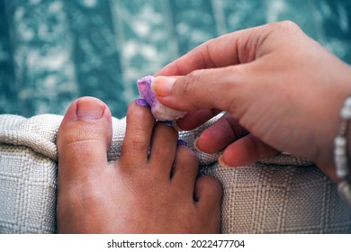 A Woman Cleaning Nail Polish From Foot Toe. Close Up Foot Toe.