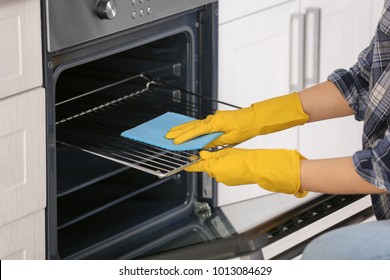 Woman Cleaning Oven In Kitchen, Closeup