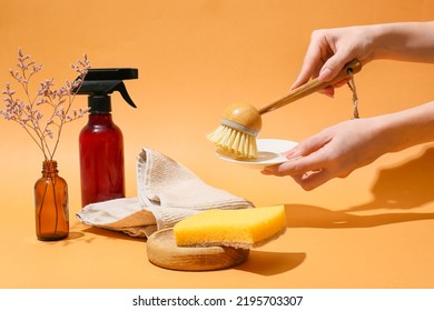 Woman Cleaning Plate With Brush On Color Background