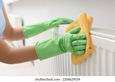 Woman Cleaning Radiator With Rag Indoors, Closeup