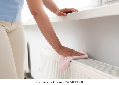 Woman Cleaning Radiator With Rag Indoors, Closeup