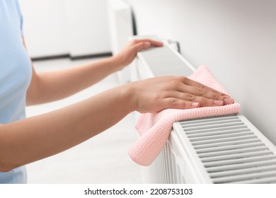 Woman Cleaning Radiator With Rag Indoors, Closeup