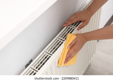 Woman Cleaning Radiator With Rag Indoors, Closeup