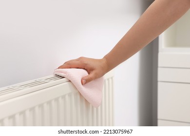 Woman Cleaning Radiator With Rag Indoors, Closeup