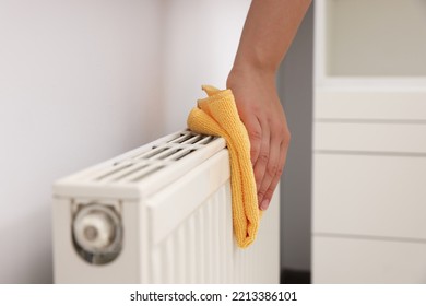 Woman Cleaning Radiator With Rag Indoors, Closeup