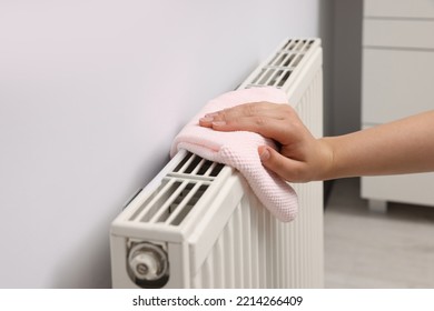 Woman Cleaning Radiator With Rag Indoors, Closeup