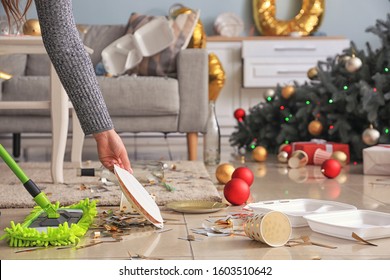 Woman Cleaning Up Room After New Year Party