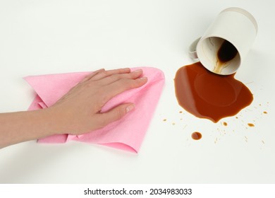 Woman Cleaning Spilled Coffee On White Background, Closeup