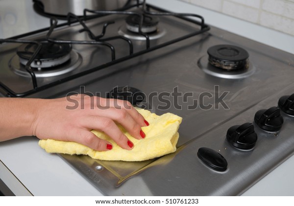 Woman Cleaning Stainless Steel Gas Surface Royalty Free Stock Image