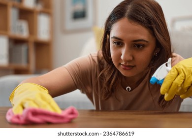 Woman, cleaning and table with gloves, face and spray at home, detergent and housework in fresh, living room and maintenance. Mexican person, cloth and housekeeping for bacteria, furniture or surface - Shutterstock ID 2364786619