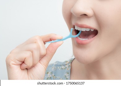 A Woman Cleaning Teeth With Dental Floss , Dental care , Tooth decay concept.