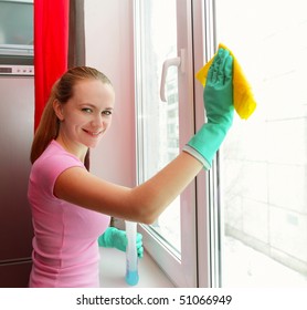 Woman Cleaning Window At Home