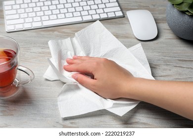 Woman Cleaning Wooden Table With Paper Towel, Closeup