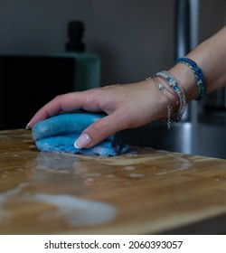 Woman Cleaning Worktop In The Kitchen