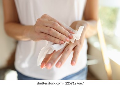Woman cleans hand with wet wipes close up. Hygiene and skin care concept. - Shutterstock ID 2259127667