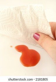 Woman Cleans Up A Spill With A Paper Towel