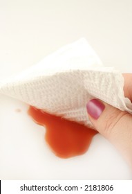 Woman Cleans Up A Spill With A Paper Towel