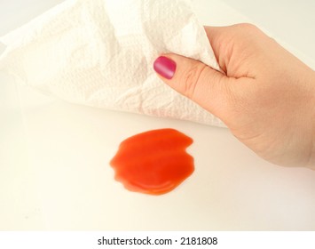 Woman Cleans Up A Spill With A Paper Towel