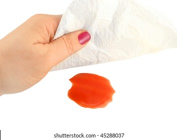 Woman Cleans Up A Tomato Juice Spill With A Paper Towel On A White Background