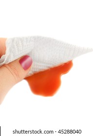 Woman Cleans Up A Tomato Juice Spill With A Paper Towel On A White Background