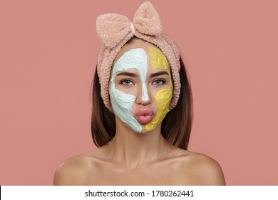 Woman Cleansing Facial Mask. Clay Of Blue-yellow Cream Covers Part Of The Face. Home Headband. Blow A Kiss