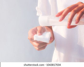 Woman With Cleansing Toner Bottle And Cotton  To Clear Skin.