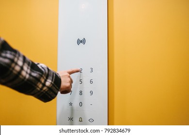 A Woman Clicks On An Electronic Button In A Modern Elevator. Inside The Elevator.