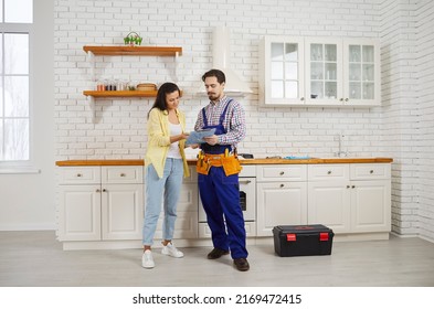 Woman client sign deal after good maintenance service, thank plumber or mechanic for work. Male repairman make agreement with customer. Good quality plumbing household service. - Shutterstock ID 2169472415