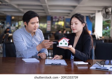 Woman Client Signs A Rental Application Form For A New House. Real Estate Agent Meets With Her Potential Client.