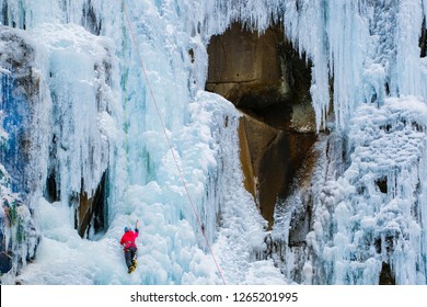 Woman Climber Climbing Ice Wall