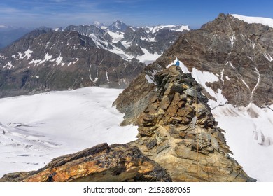 woman climber on a dangerous ascent of exposed ridge of Dent D'Herens in the Alps