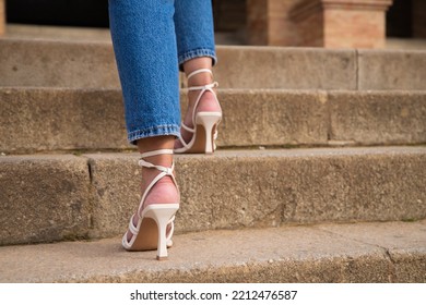 Woman Climbing Stairs In High Heels. You Can See Her Feet Going Up The Steps.