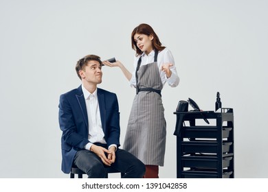 Woman With A Clipper Does A Haircut To A Man Professional Barbershop