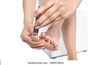 Woman clipping her toenails. isolated on white background. - Shutterstock ID 1389573674